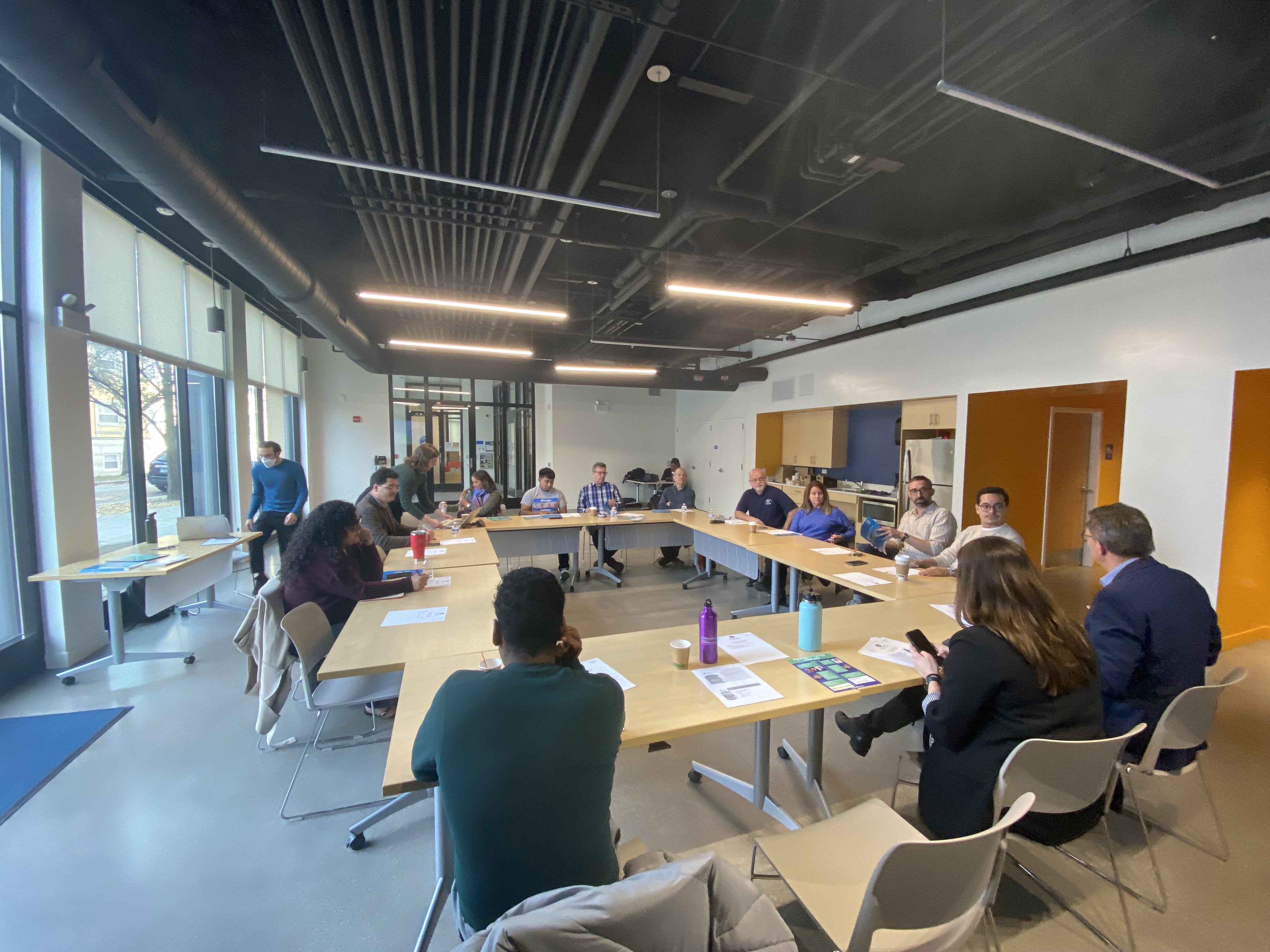 Meeting with attendees sitting around tables